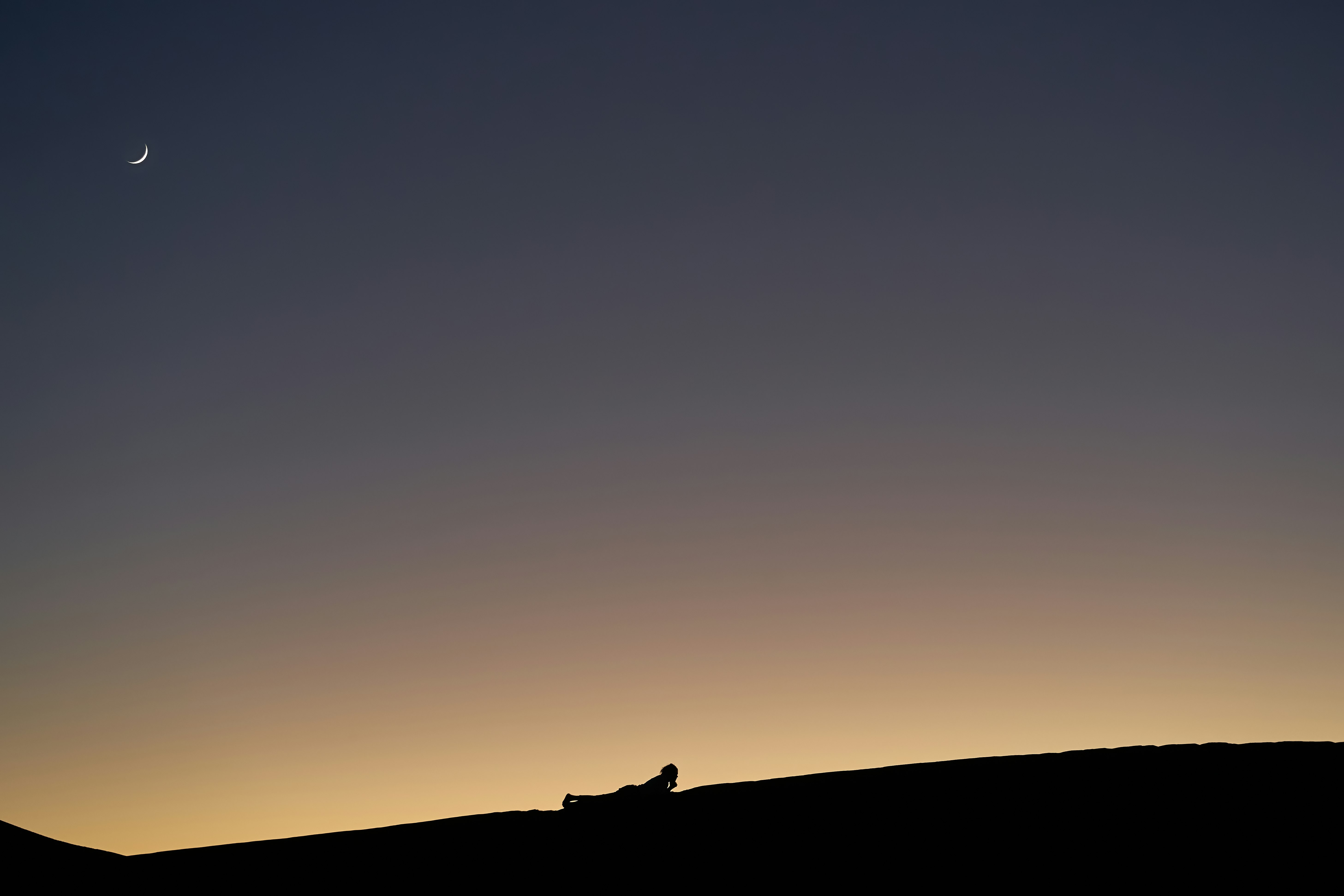 silhouette photo of mountains and moon